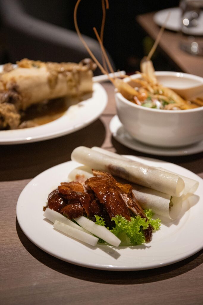 Savory Peking duck with fresh vegetables and dips, perfectly plated.